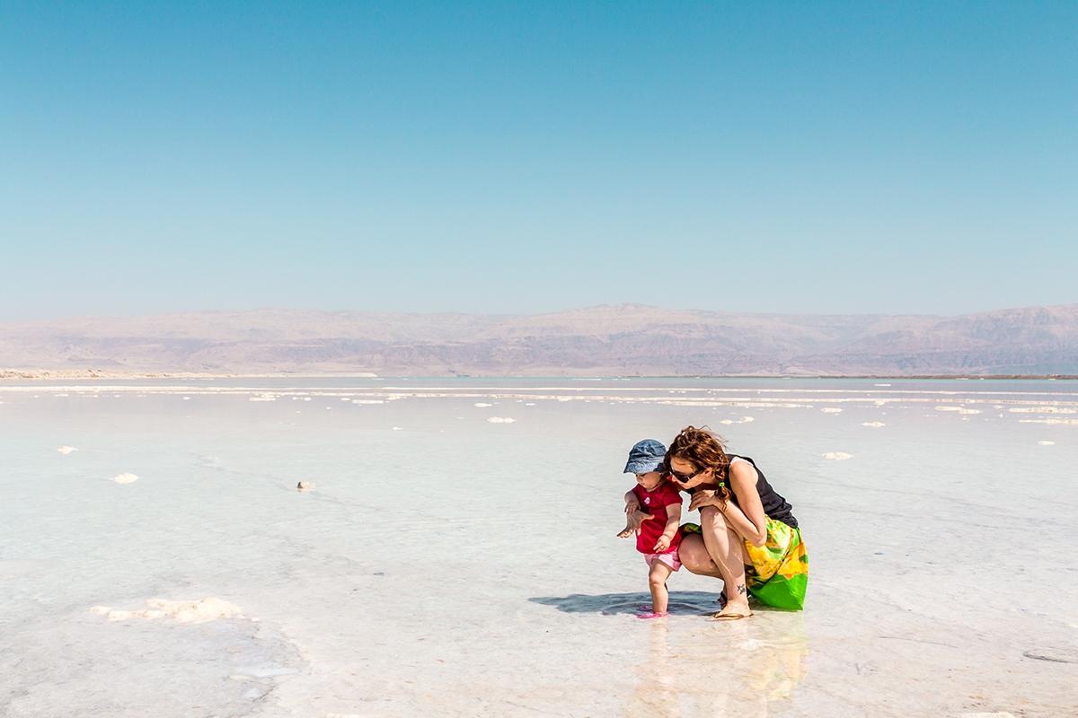 Mother and baby daughter in the shallow water of Dead Sea