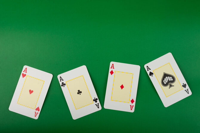 Playing cards isolated on green background.