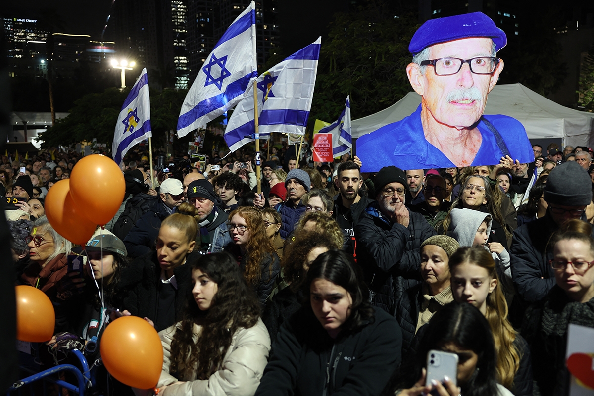 Crowds gathered at hostage square in Tel Aviv, carry a large cutout of late Oded Lifshitz, hours after the Palestinian group Hamas handed over the bodies of four hostages, including Lifshitz', from the Gaza Strip on February 20, 2025.. A minute of silence took place at the start of a rally in solidarity with the families of the dead hostages, who Hamas say include three members of the Bibas family, who have become symbols of the hostage crisis that has gripped Israel since the Gaza war broke out.