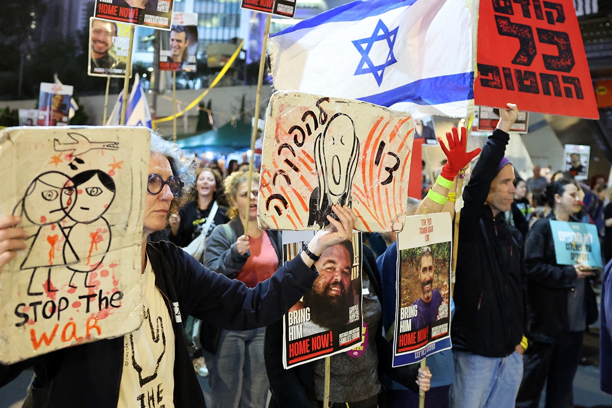 Demonstrators hold a protest calling for action to release the remaining Israeli hostages held captive in Gaza since the 2023 October 7 attacks by Palestinian militants, outside the Israeli Defence Ministry headquarters in Tel Aviv on March 18, 2025. (Photo by Jack GUEZ / AFP)